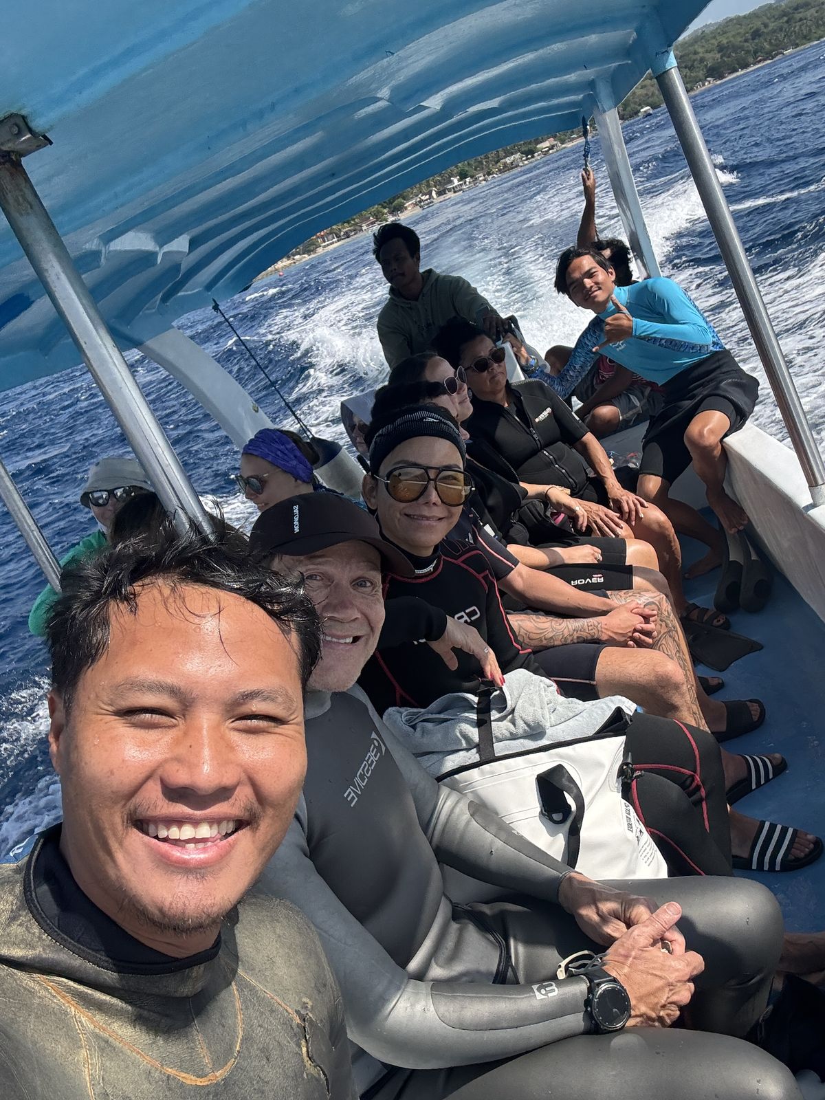 International freedivers smiling together on a training boat