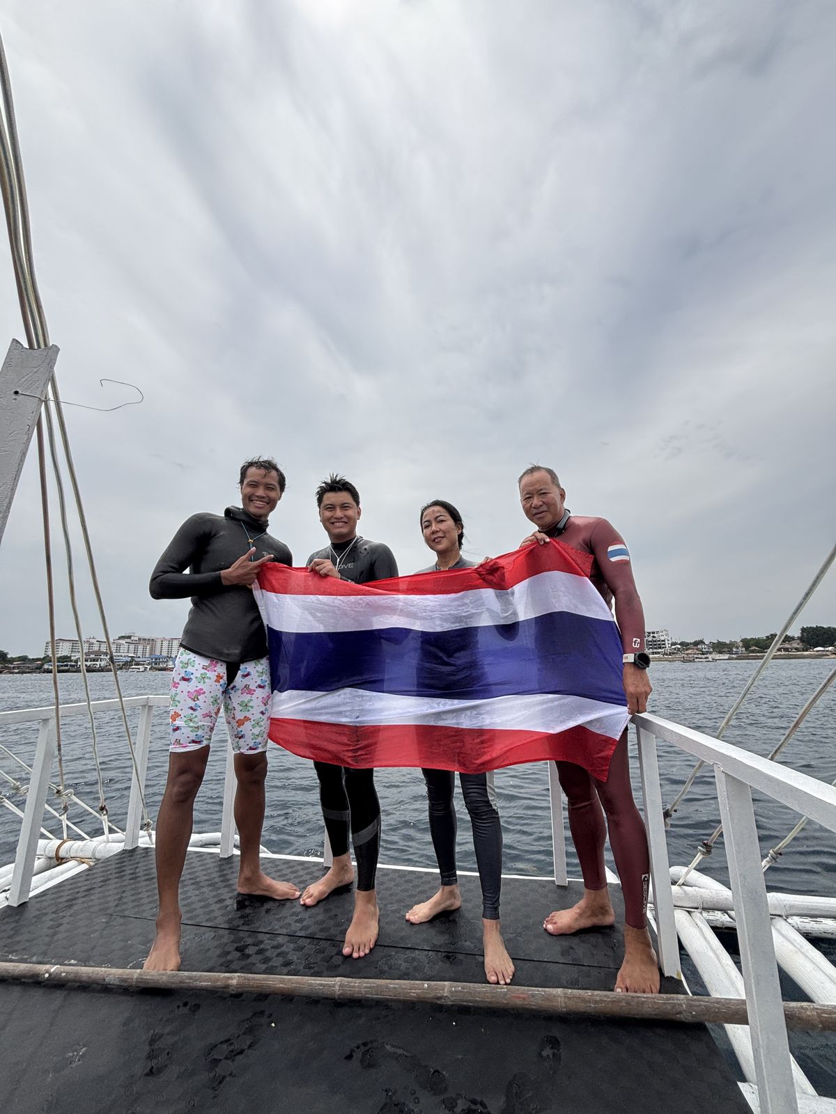 Thai freediving team celebrating together after an open-water session